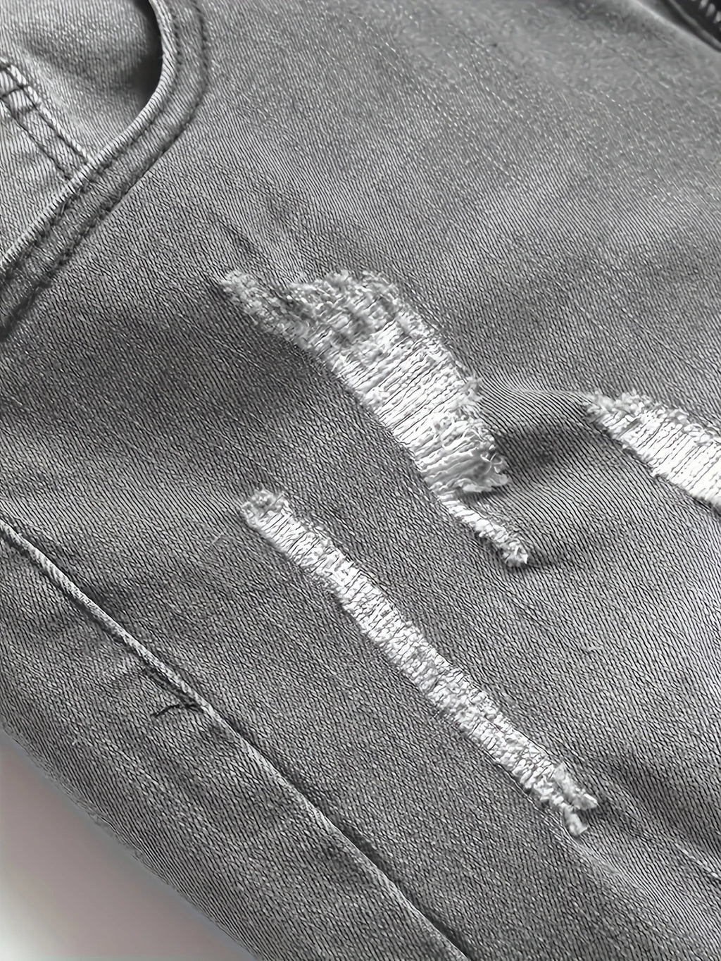 Men's gray skinny jeans with large rips, featuring a unique distressed design that fits the body shape perfectly, making it easy