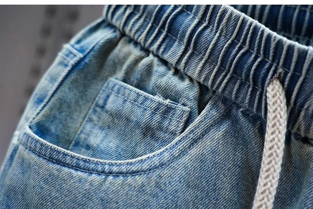 Men's distressed ripped drawstring and cuffed jeans with rivet embellishments high-street slim-fit trousers brand men clothing