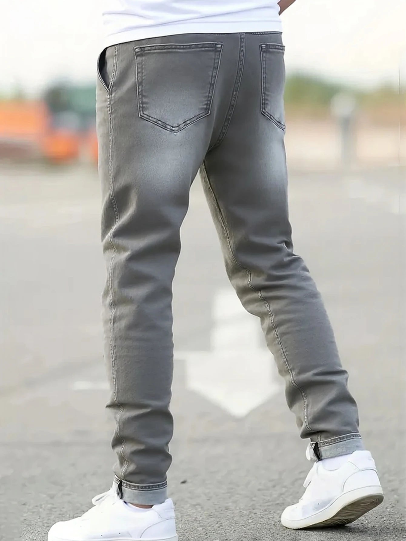 Men's gray skinny jeans with large rips, featuring a unique distressed design that fits the body shape perfectly, making it easy