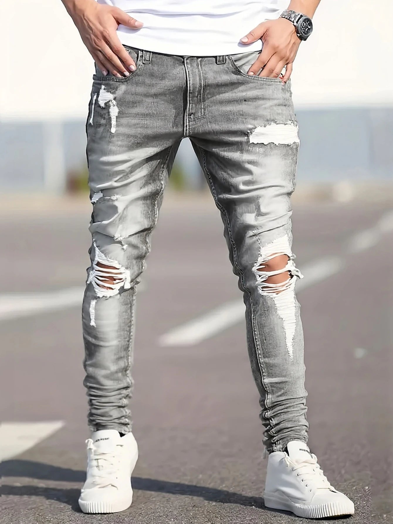 Men's gray skinny jeans with large rips, featuring a unique distressed design that fits the body shape perfectly, making it easy